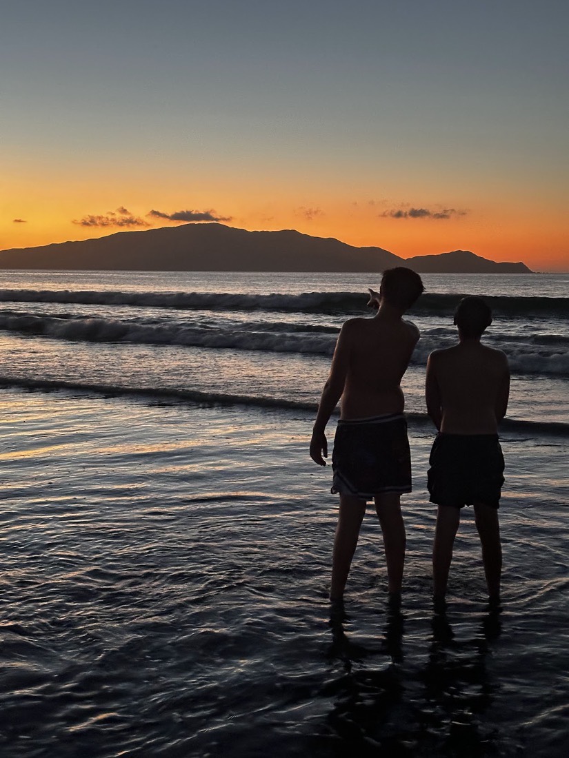 Pointing at the horizon, Kāpiti Island at dusk